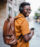 Shot of a young man using smartphone and listening to music outdoor in the city.